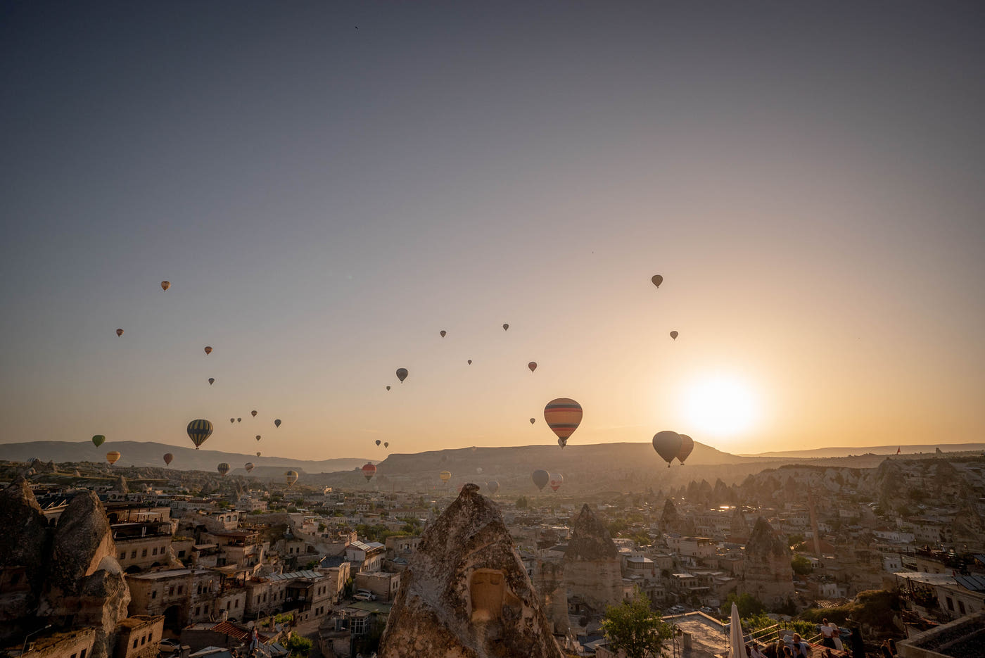 Hot air balloons rising at sunrise
