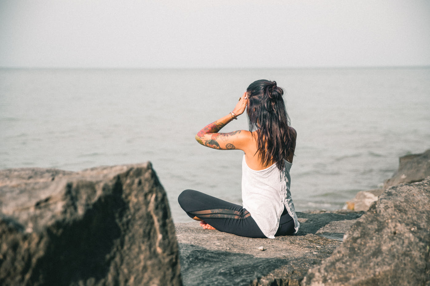 A woman meditating by the sea