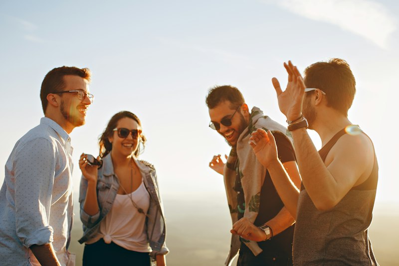Friends laughing together at sunset